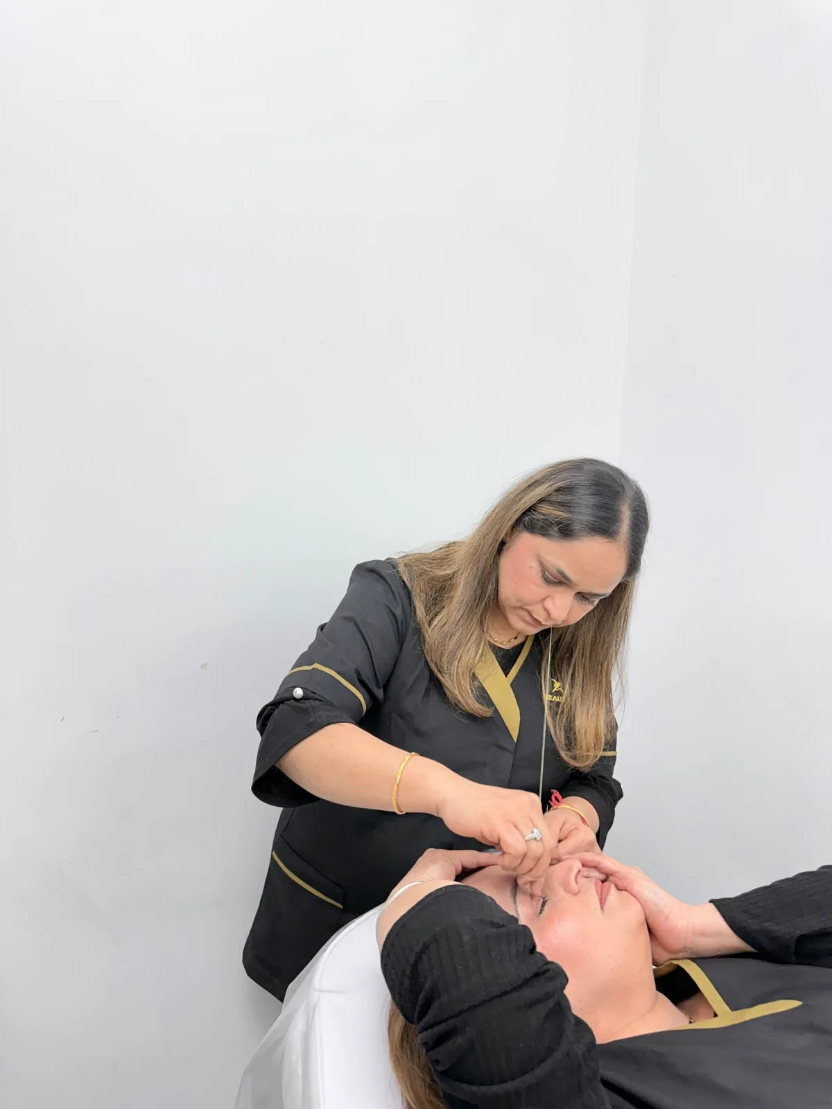 A team member caring for a client in a beauty treatment chair