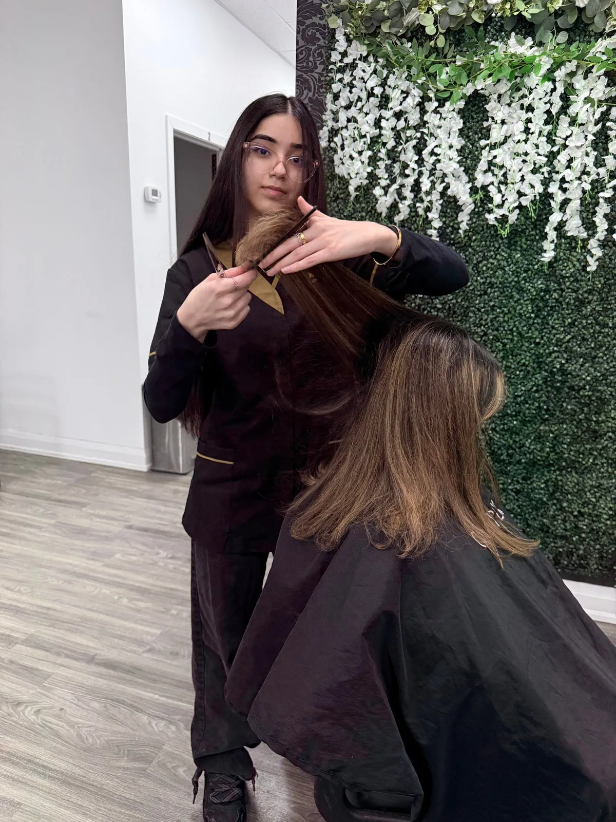 A stylist working on a client’s hair at Xtreme Beauty Lounge