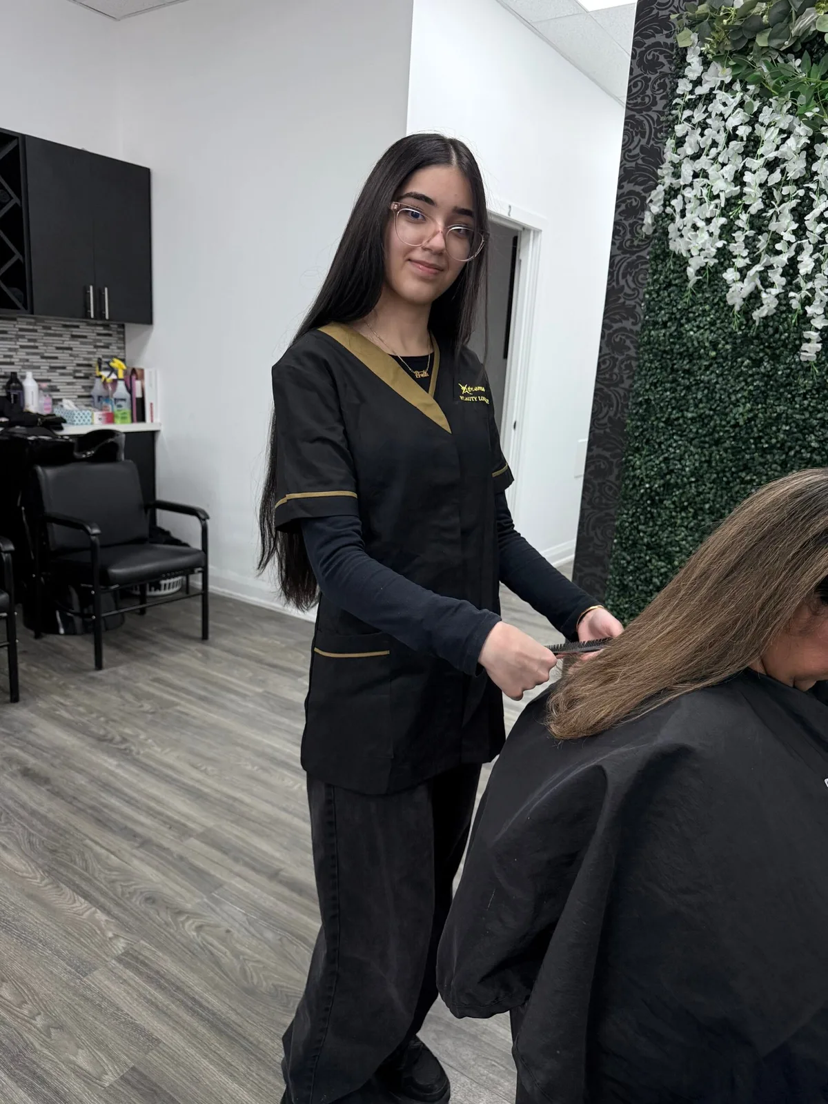 A stylist caring for a client at a salon station